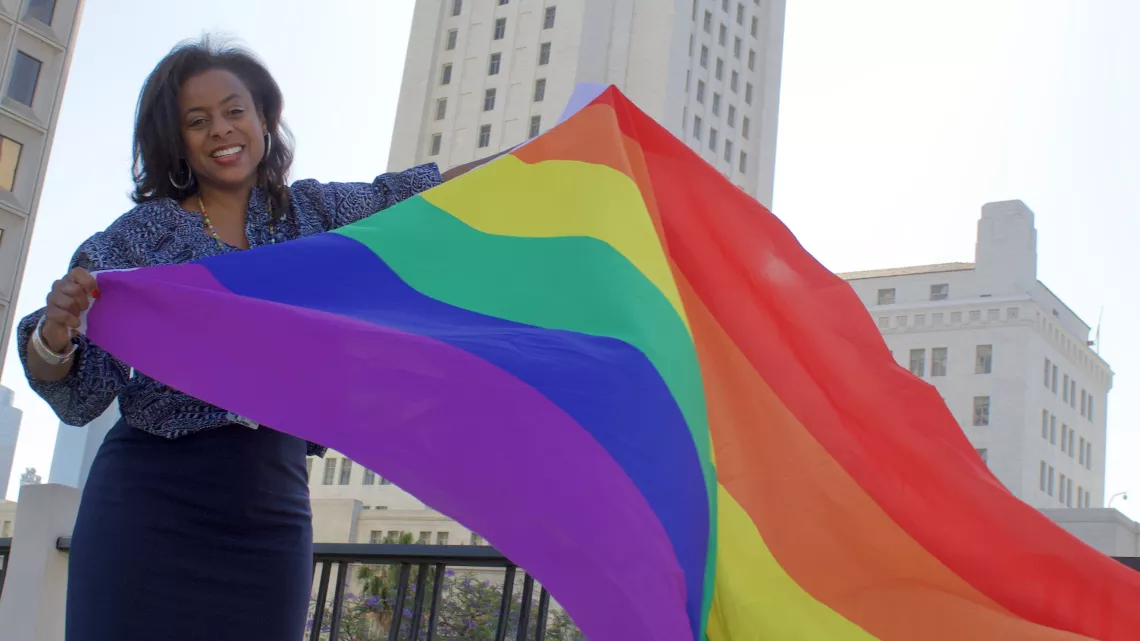 Capri Maddox with a Pride Flag in front of LA City Hall on June 30th, 2022.