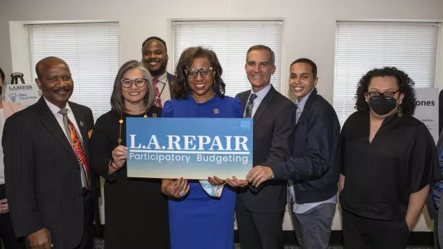 Mayor Eric Garcetti, Councilwoman Monica Rodriguez, LA Civil Rights Executive Director Capri Maddox and others hold an L.A. REPAIR Participatory Budgeting sign