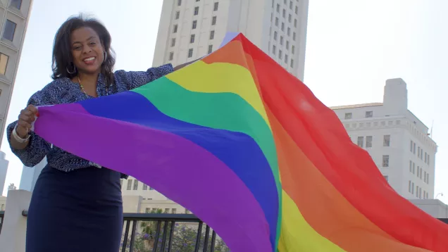 Capri Maddox with a Pride Flag in front of LA City Hall on June 30th, 2022.